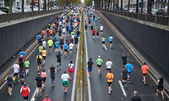 A group of people on two streets completing a marathon