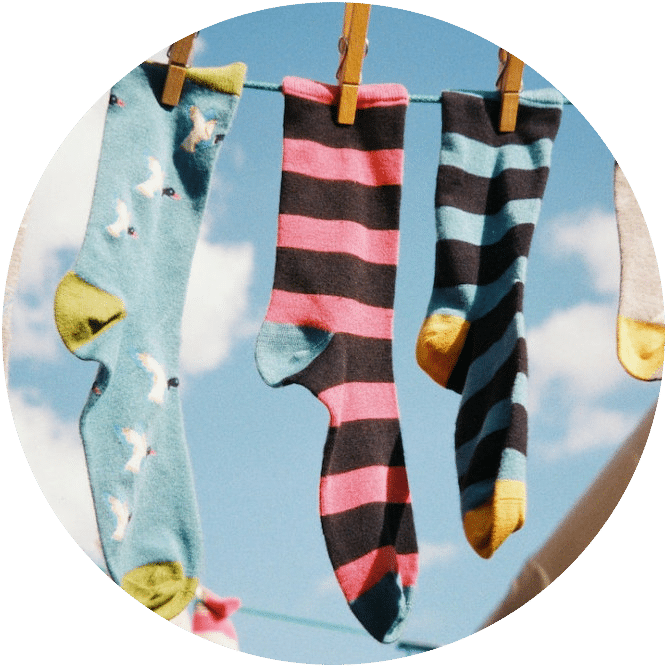 Colorful long socks hanging from a clothes line